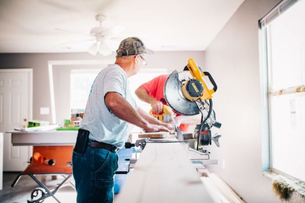 Professional kitchen fitter installing bespoke cabinets on-site during a Mastercraft Kitchens project