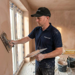 Mastercraft Kitchens tradesman plastering a wall during kitchen renovation works, part of the full building and installation service delivered before fitting a bespoke Mastercraft kitchen.