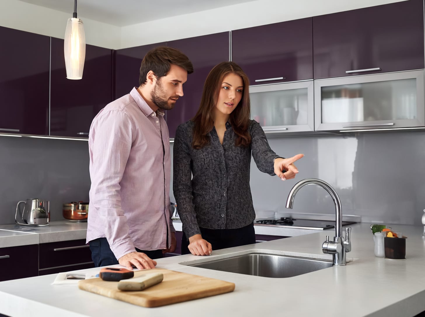 Susan in kitchen with client a Mastercraft desgner dicusiing ideas in the customer's kitchen