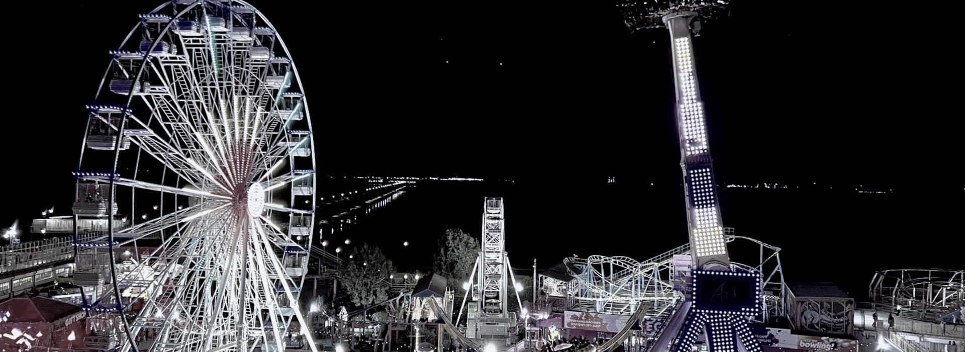 Bespoke Kitchens Southend-on-Sea - Mastercraft Kitchens illuminated Ferris wheel and amusement rides against a dark night sky