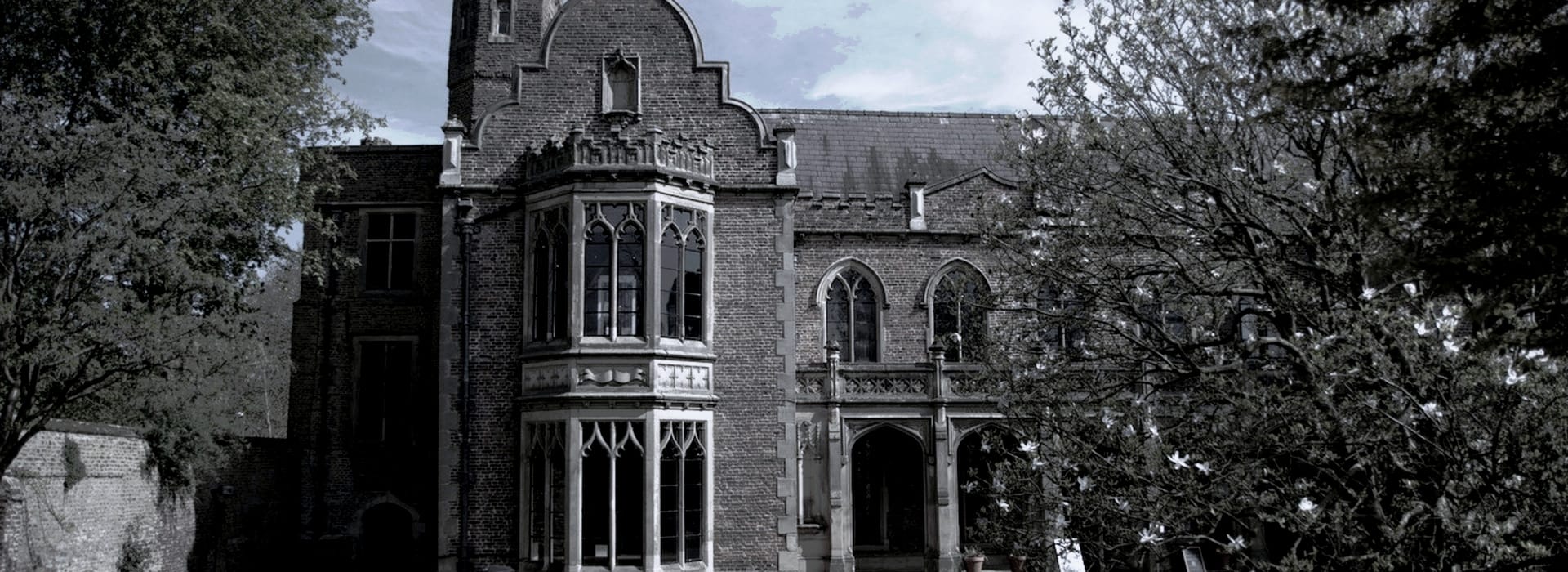 gothic style brick building with arched windows and ornate stone detailing