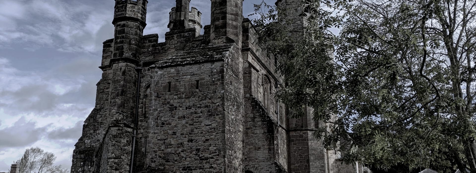 stone castle with tall towers and weathered grey walls