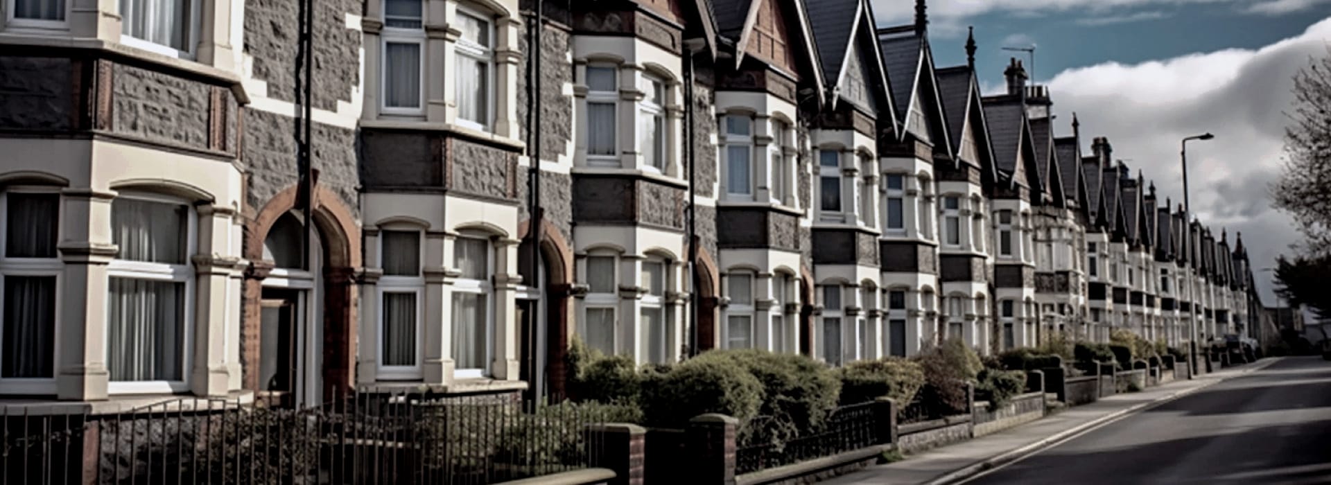 row of Victorian terraced houses with pointed roofs and bay windows