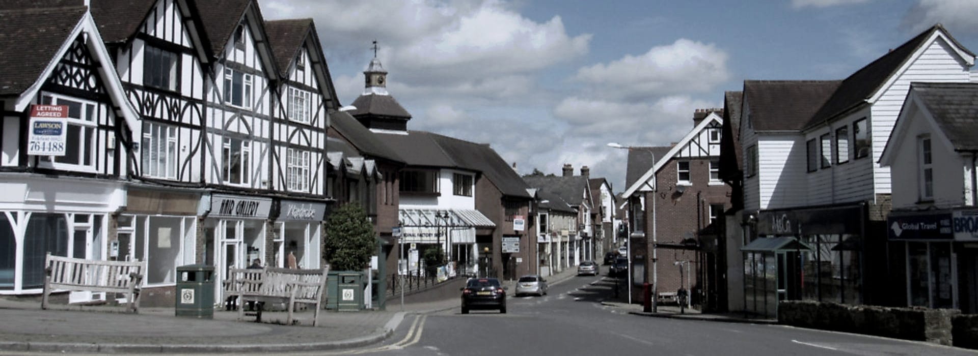 black and white timber-framed buildings along a quiet village street