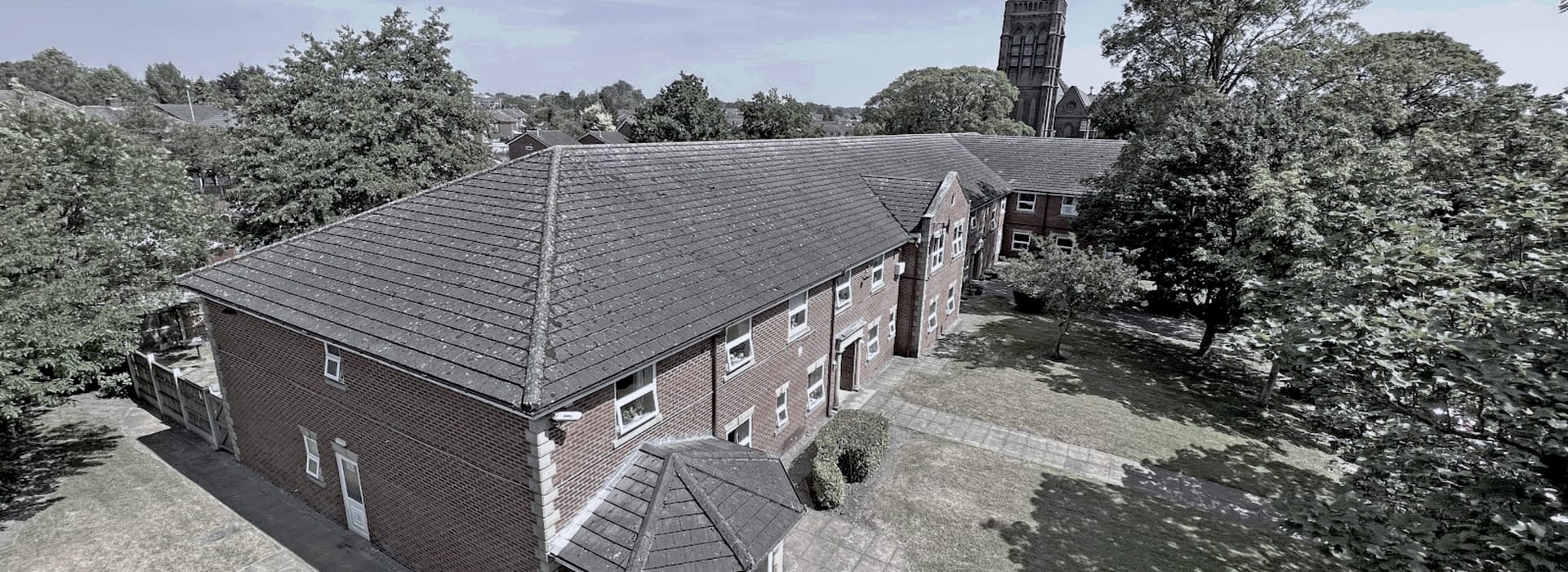 Bespoke Kitchens Ferndale - Mastercraft Kitchens red brick building with pitched grey tiled roof and surrounding green trees