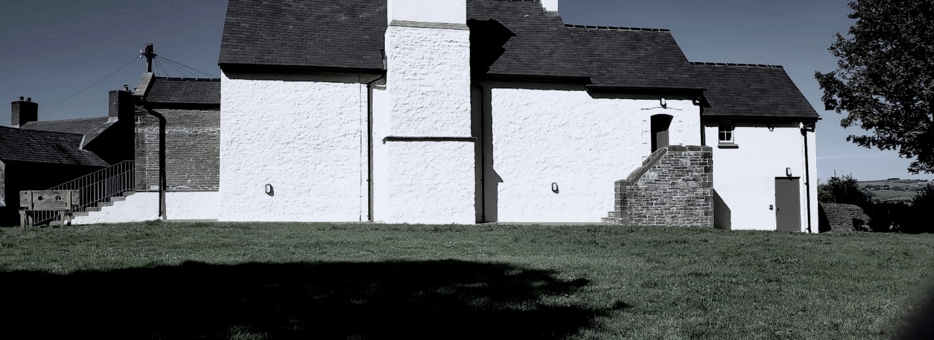 Bespoke Kitchens Llantrisant - Mastercraft Kitchens whitewashed stone building with dark roof and small stone staircase