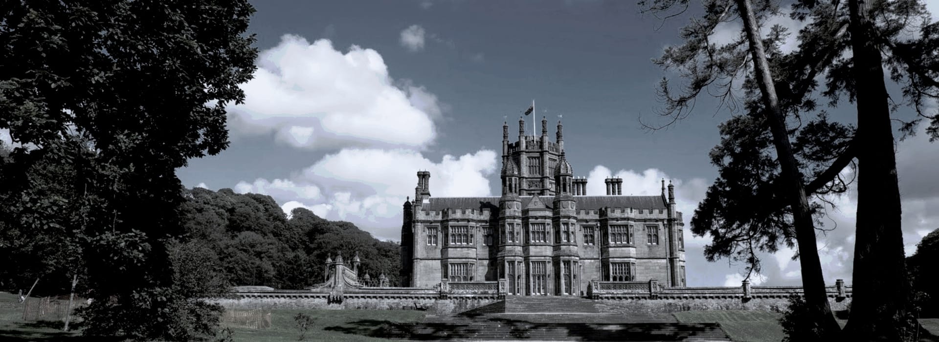 Bespoke Kitchens Port Talbot - Mastercraft Kitchens Victorian Gothic mansion with turrets, grey stone facade, surrounded by trees