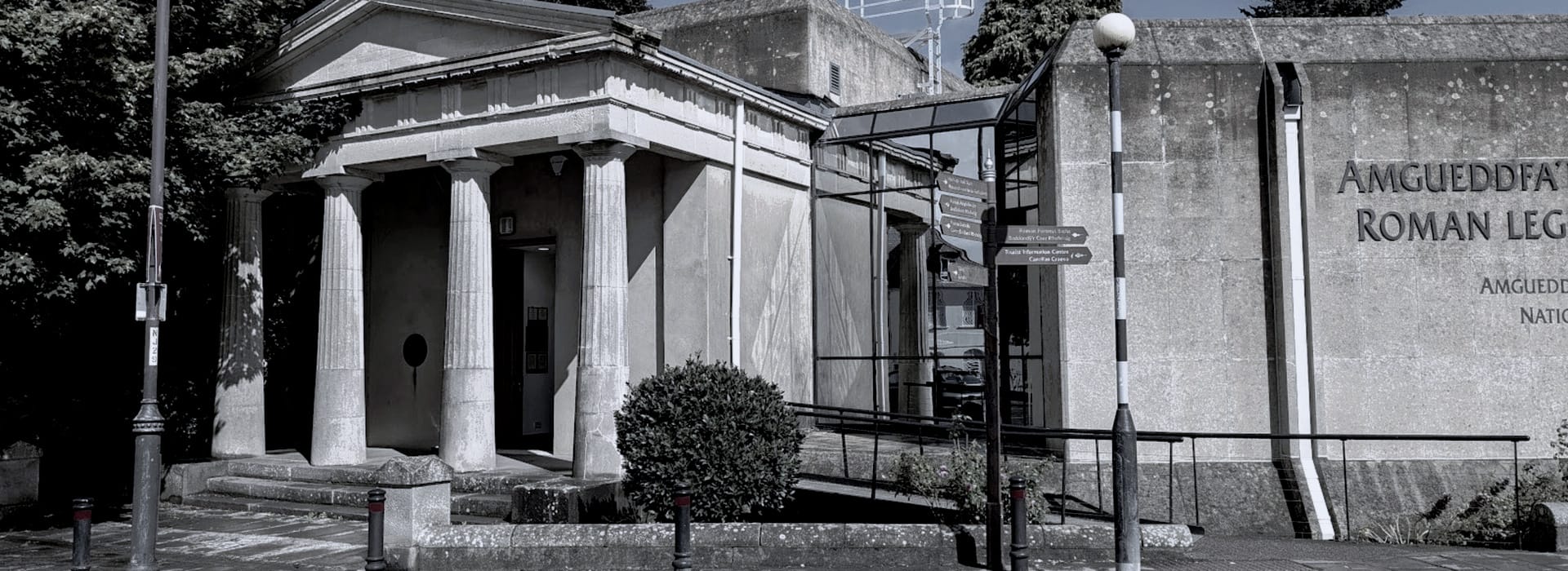 Bespoke Kitchens Caerleon - Mastercraft Kitchens grey stone building with classical columns and large engraved wall text