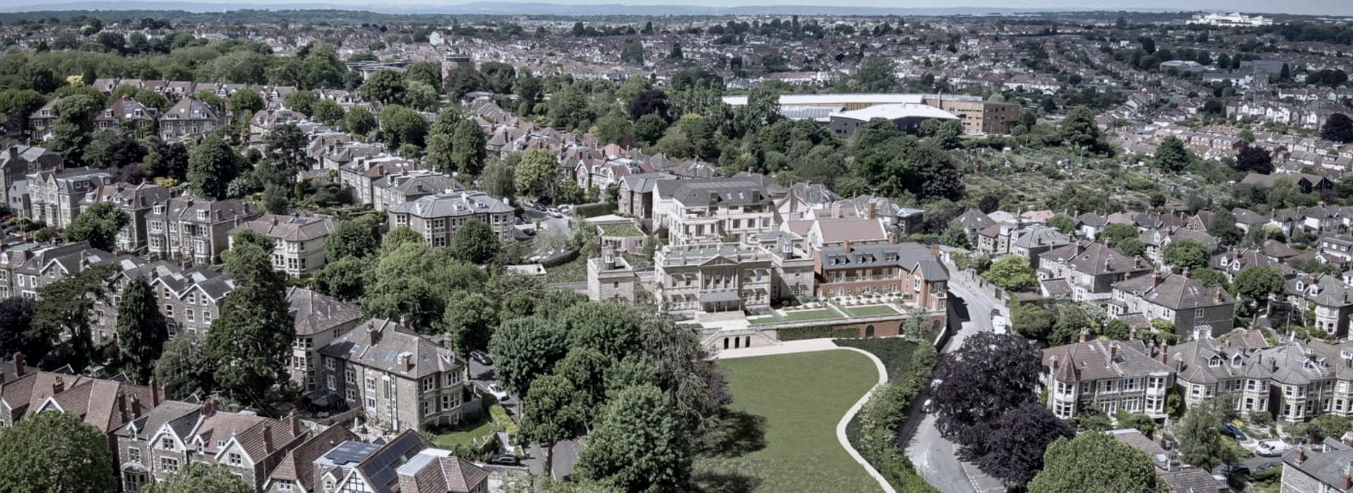 aerial view of Victorian houses with large central mansion and green lawns