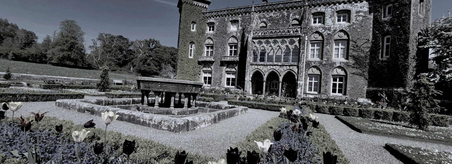 Bespoke Kitchens Llandeilo - Mastercraft Kitchens historic stone building with arched windows and formal garden with central fountain