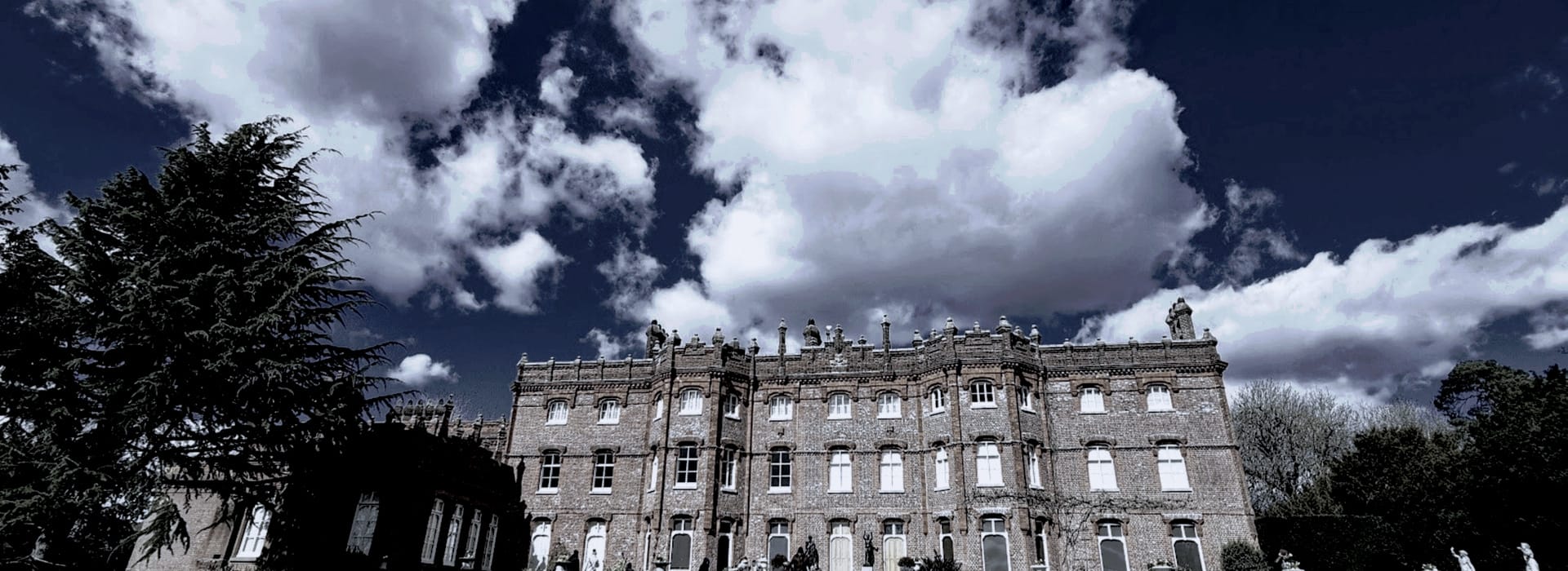 Bespoke Kitchens High Wycombe - Mastercraft Kitchens Victorian-style stone building with ornate windows under dramatic cloudy sky
