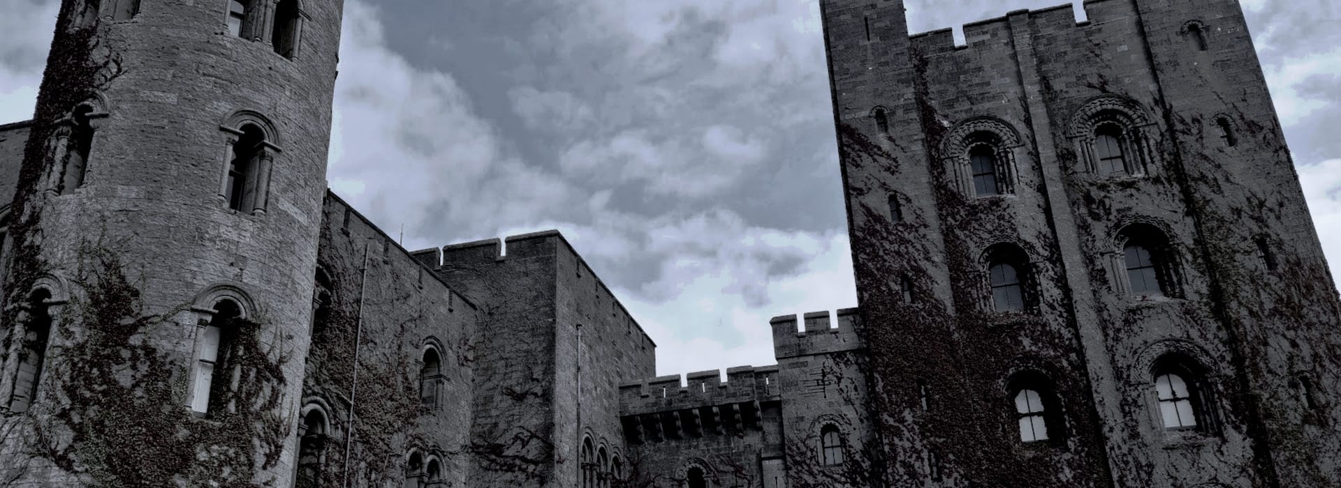 Bespoke Kitchens Caernarfon - Mastercraft Kitchens grey stone castle towers with arched windows and climbing ivy