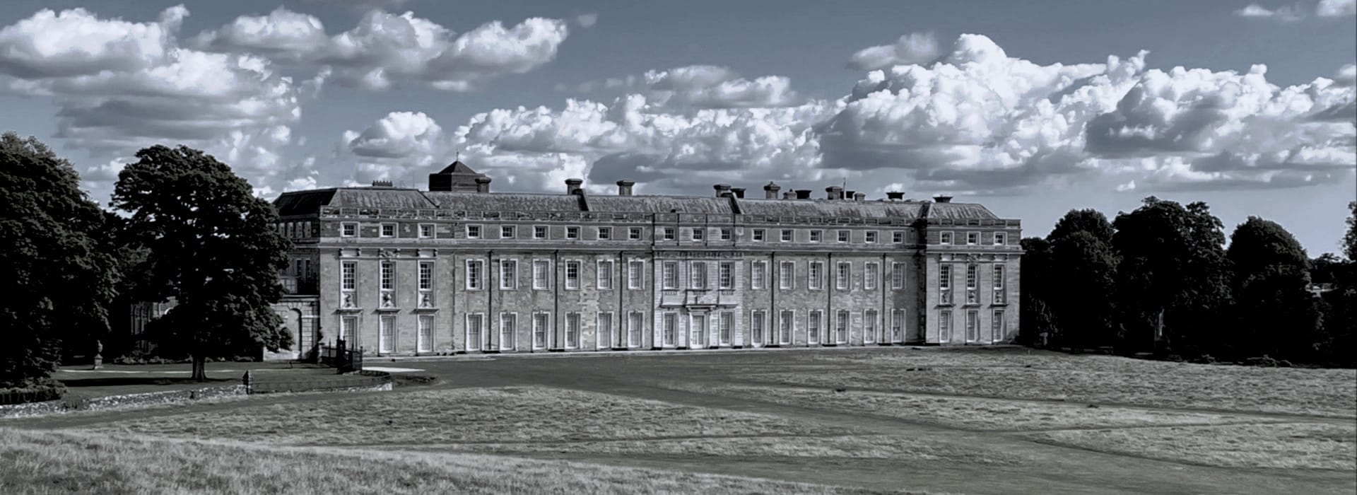 grand historic mansion with symmetrical stone facade and tall sash windows