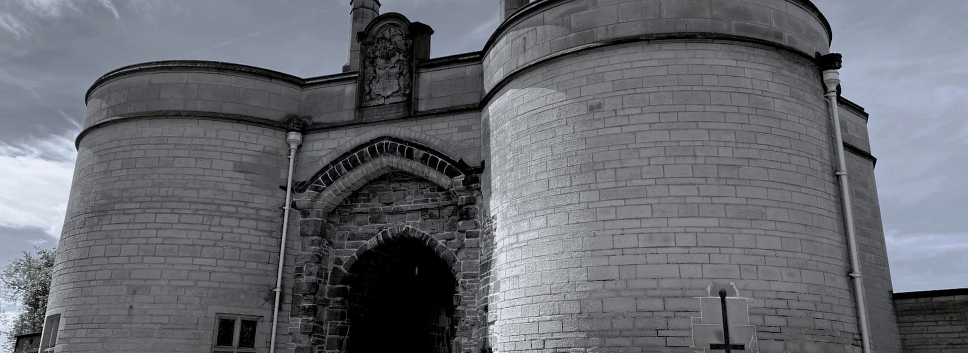 stone building with two large round towers and arched entrance