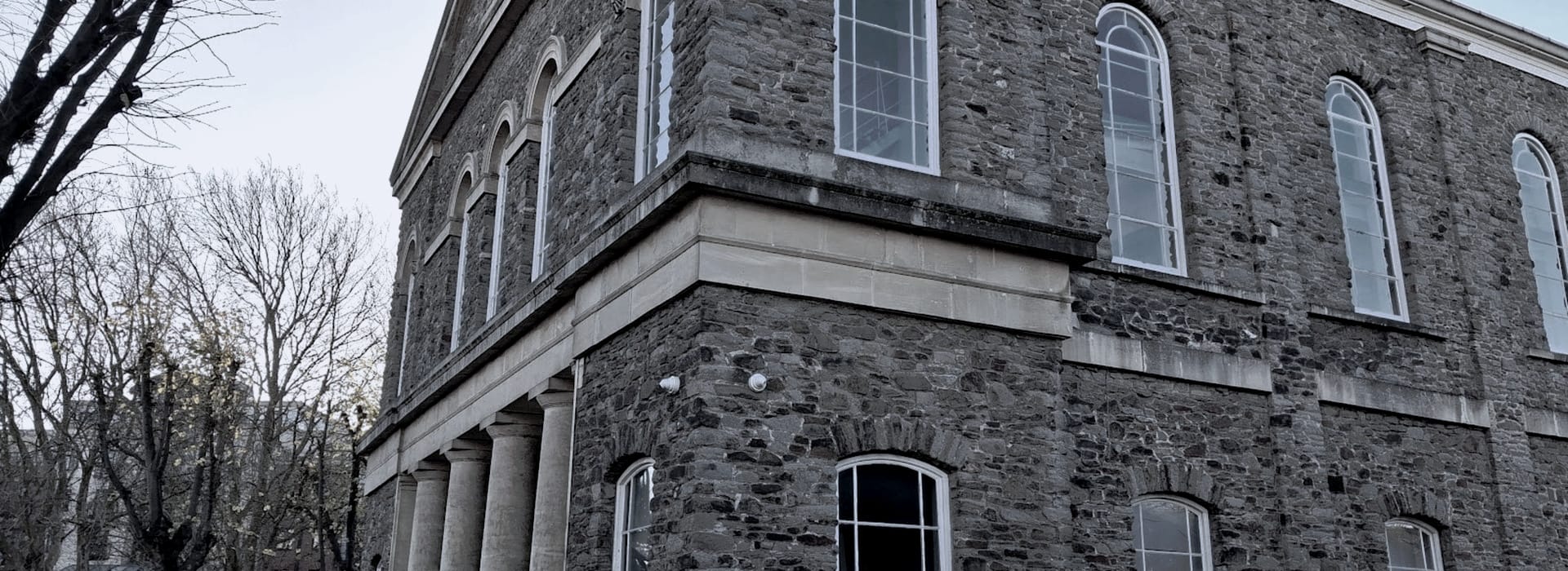 Bespoke Kitchens Bedminster - Mastercraft Kitchens stone building with tall arched windows and classical columns