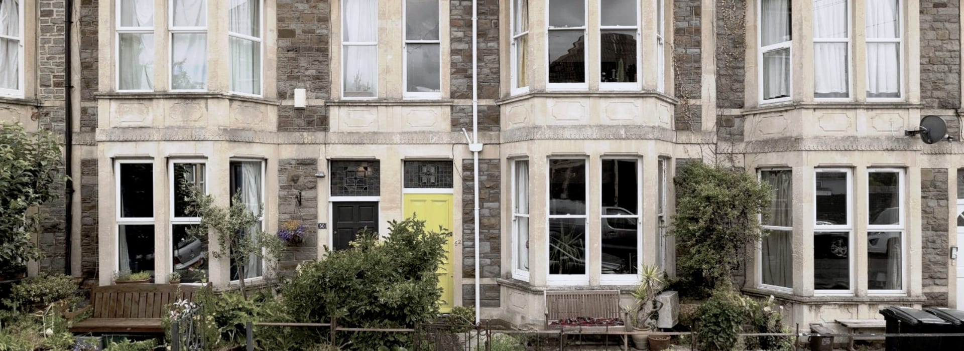 Victorian terrace with bay windows and a bright yellow front door