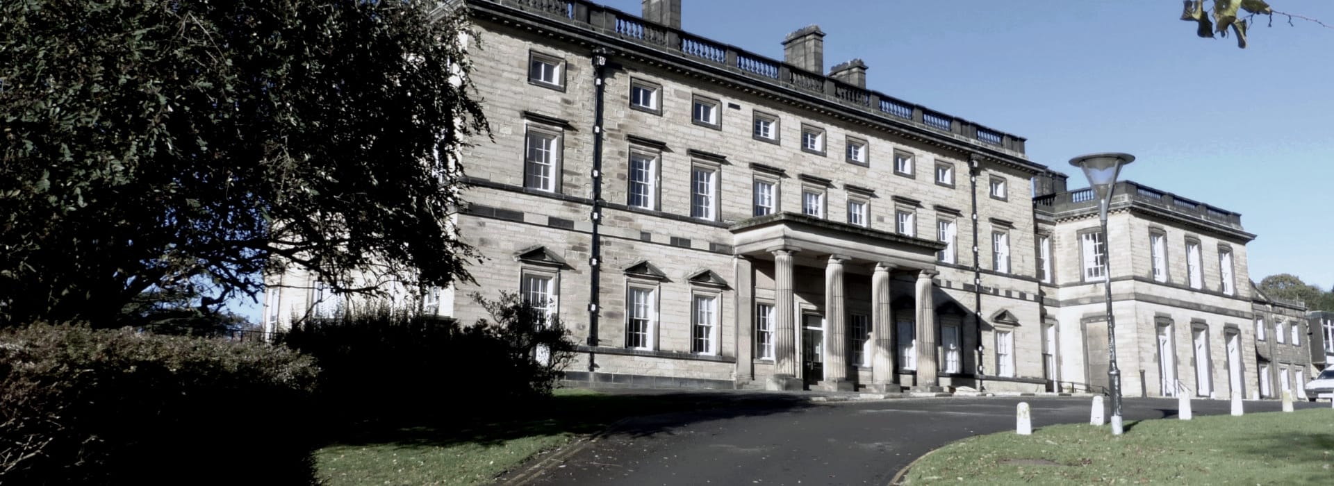 grand stone building with tall columns and symmetrical window layout