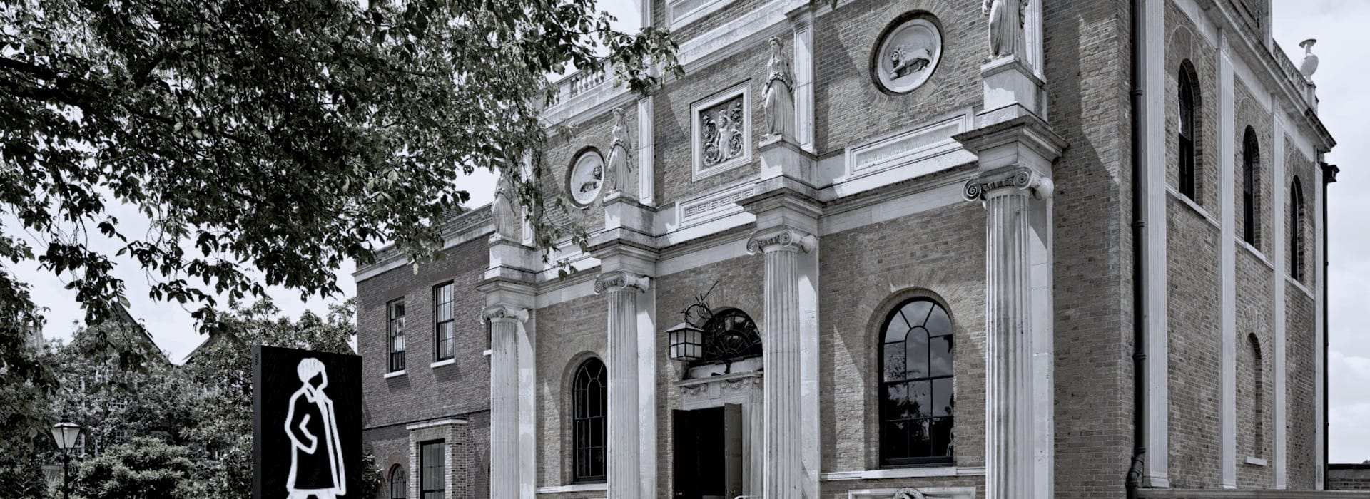 Bespoke Kitchens Ealing - Mastercraft Kitchens historic brick building with tall columns and classical statues on facade