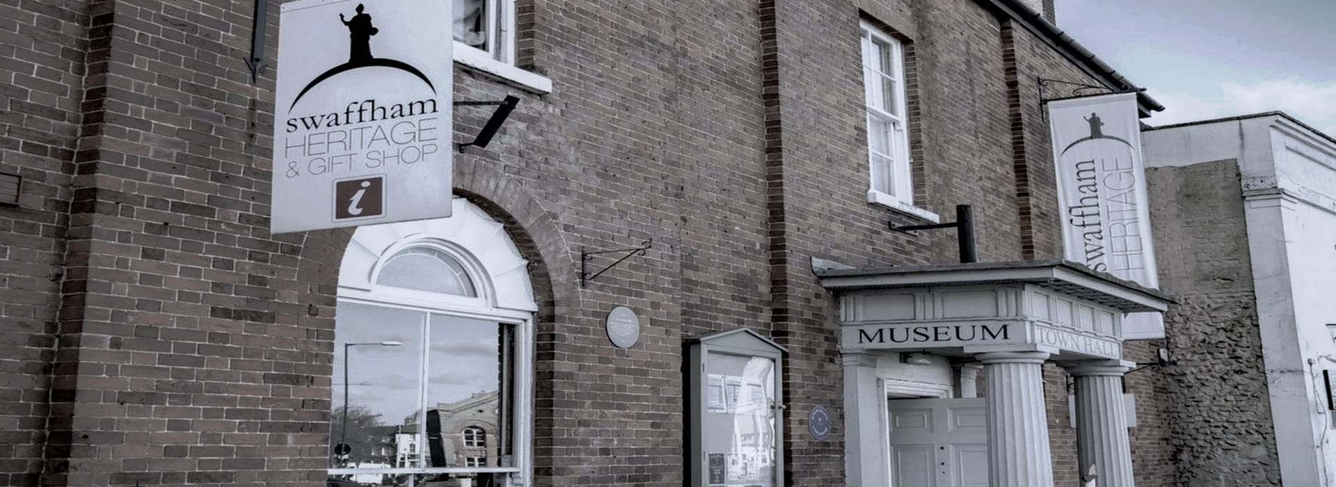 Bespoke Kitchens Swaffham - Mastercraft Kitchens red brick building with white columns and large heritage signs