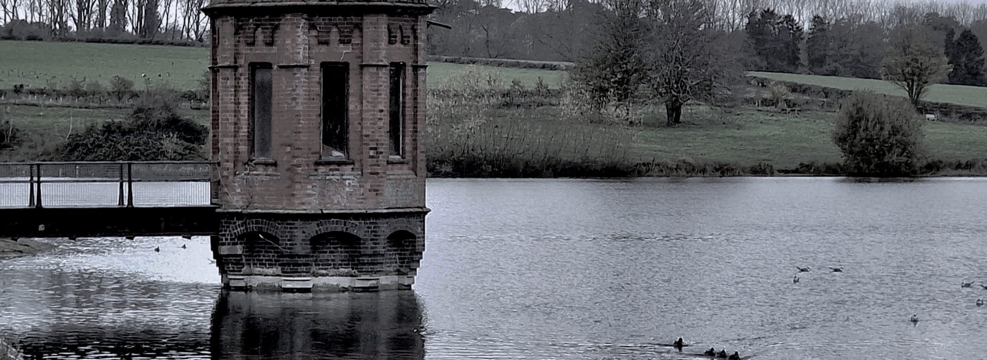 Bespoke Kitchens Wellingborough - Mastercraft Kitchens octagonal red brick tower on lake with muted green landscape