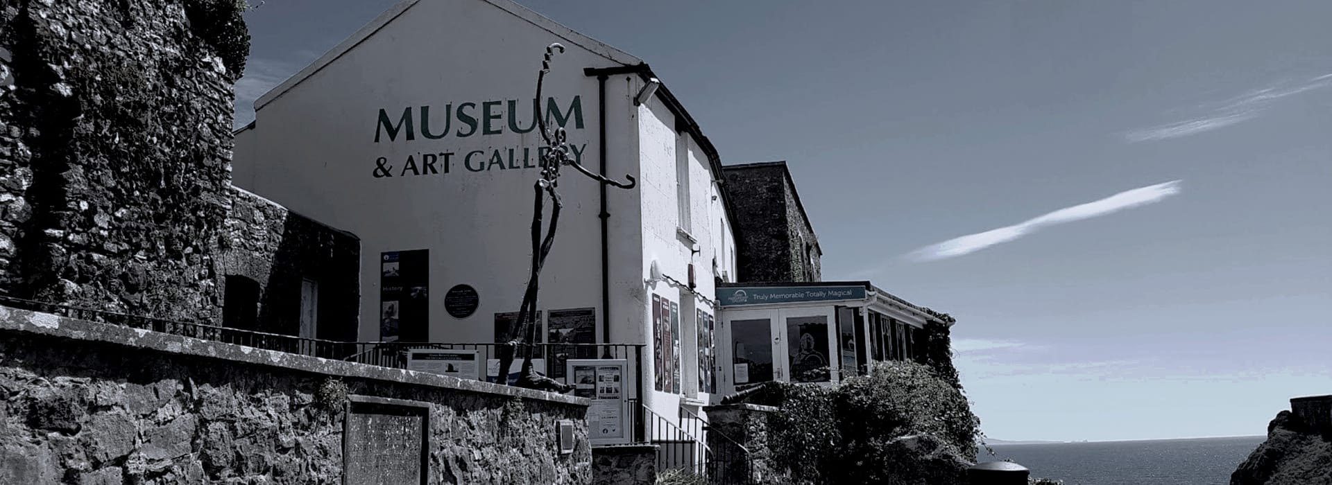 Bespoke Kitchens Tenby - Mastercraft Kitchens white museum building with tall abstract metal sculpture outside