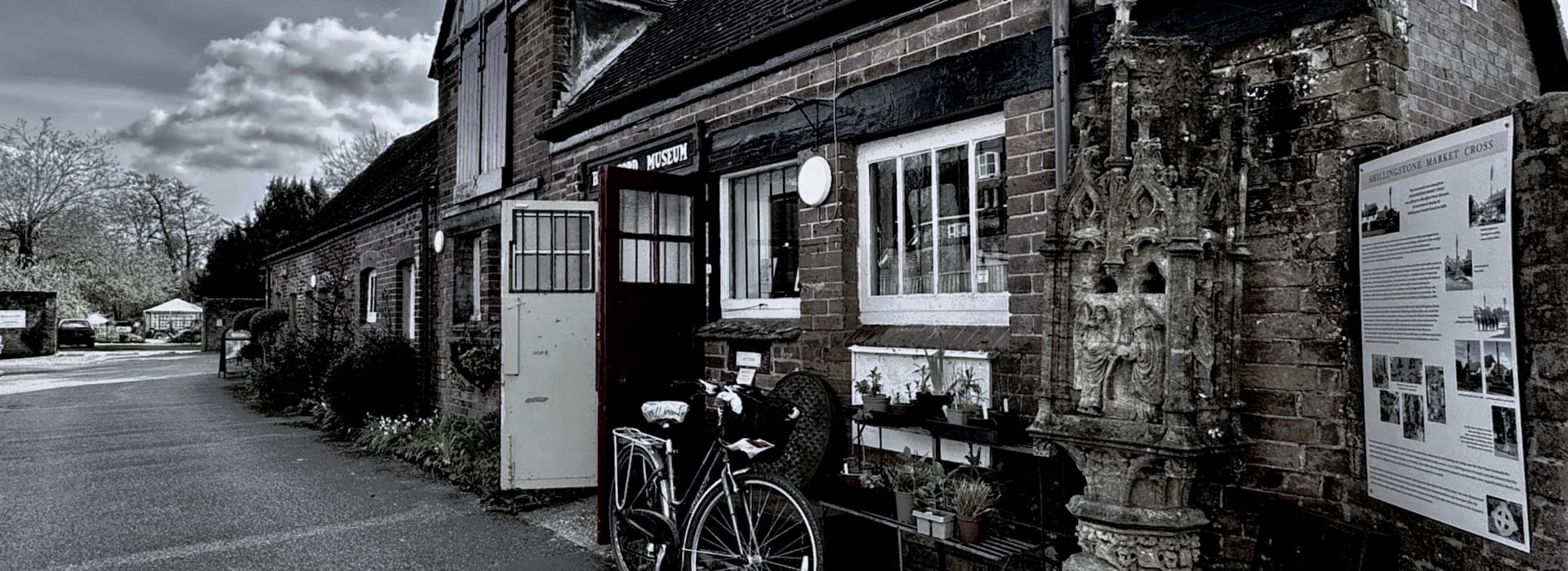 red brick building with white windows, bicycle parked by open door