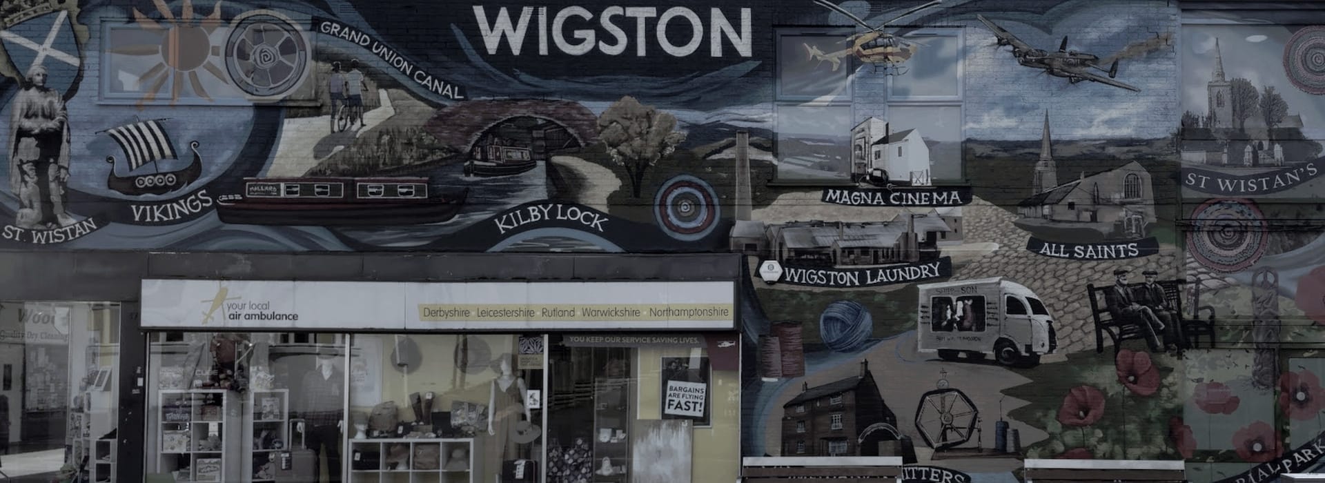 Bespoke Kitchens Wigston - Mastercraft Kitchens colourful mural with historical scenes and local landmarks on a shopfront wall