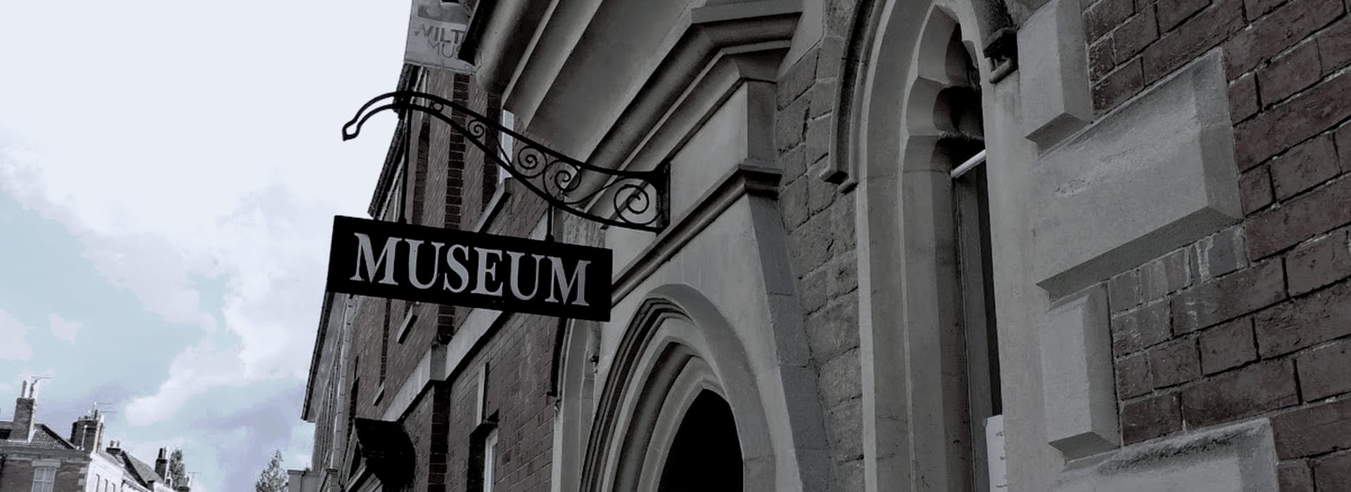 Bespoke Kitchens Devizes - Mastercraft Kitchens black museum sign with white lettering on red brick building