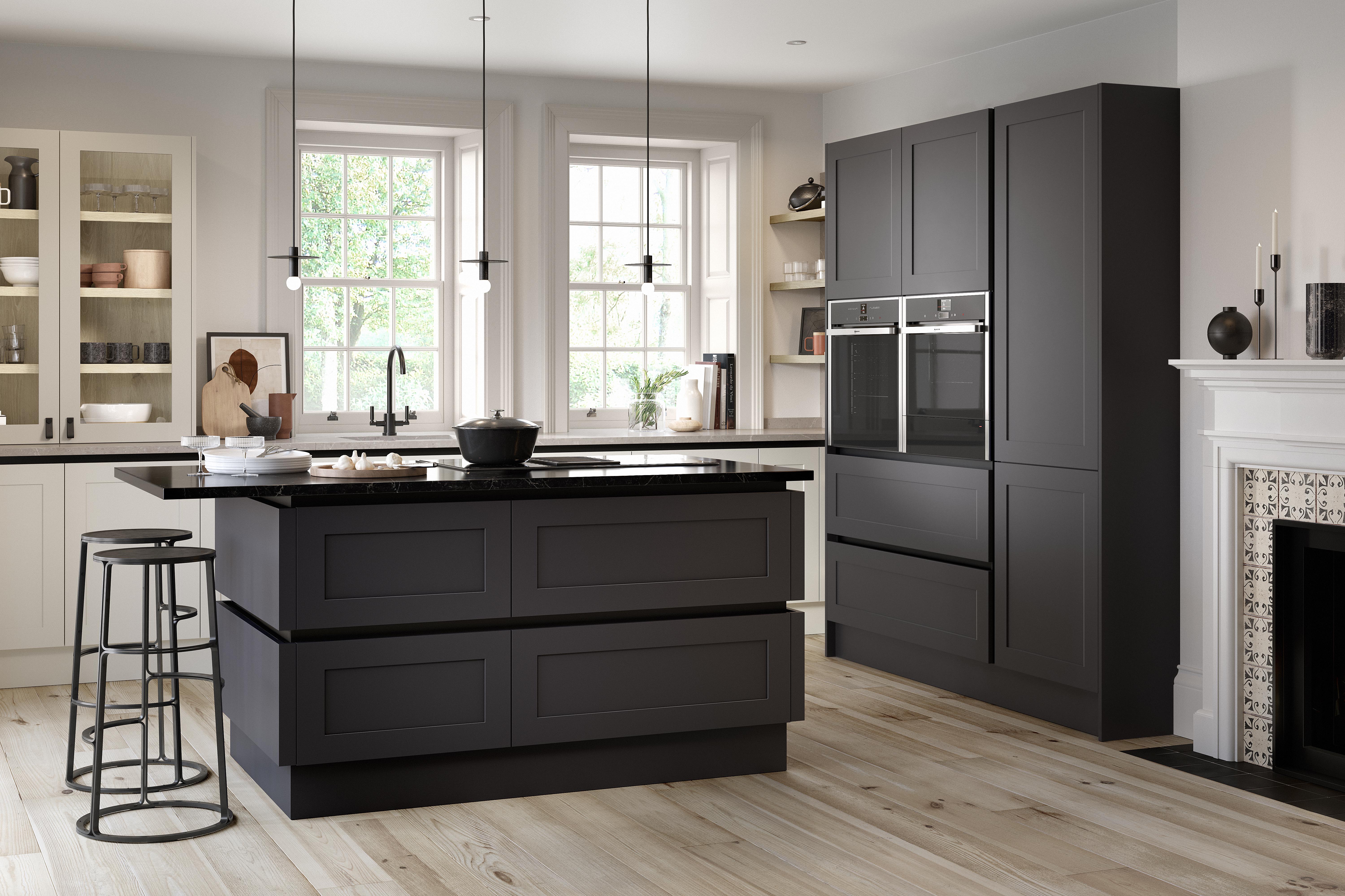 Dark grey and off-white Shaker kitchen with an island, black worktops, pendant lighting and wood flooring